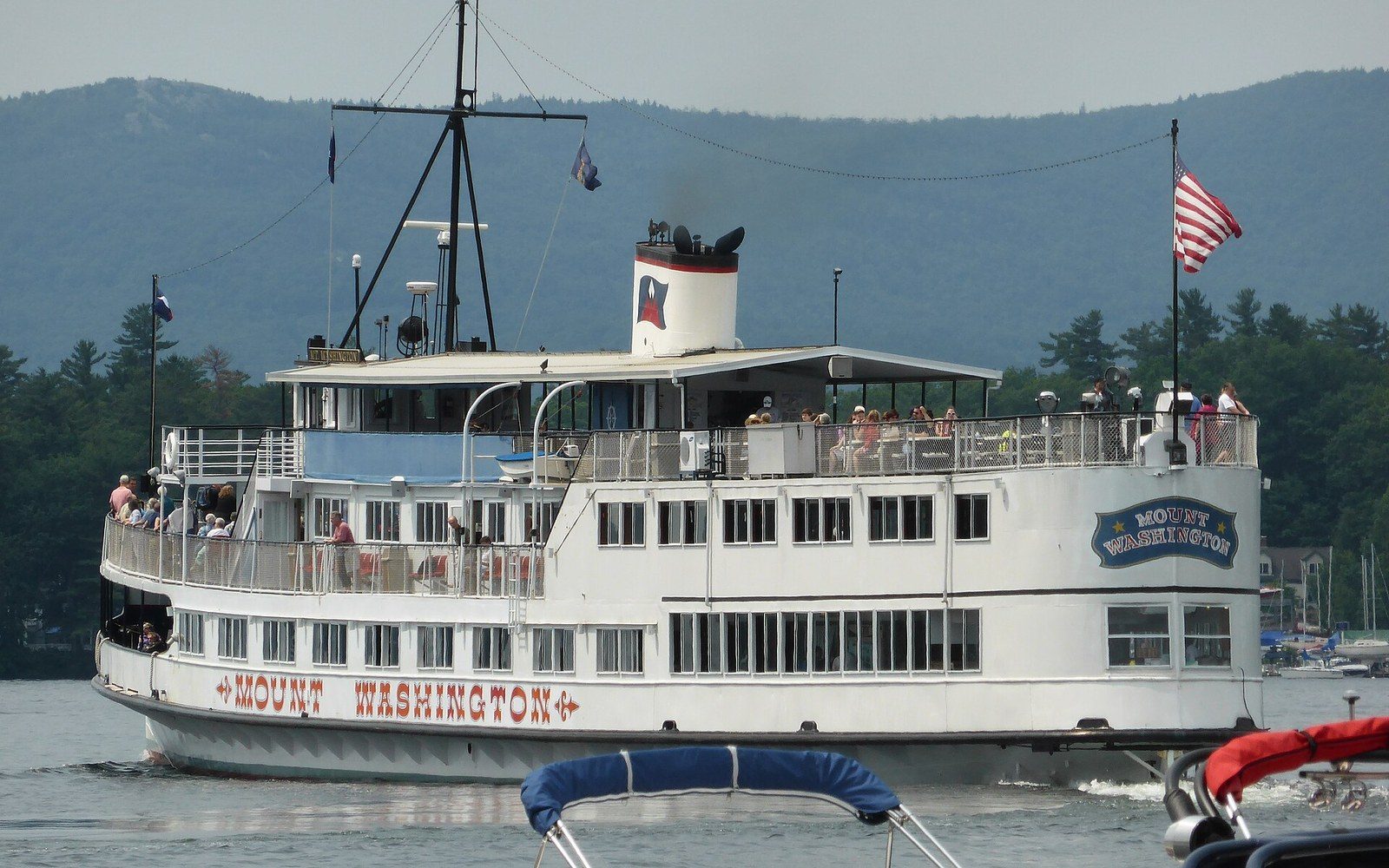 The Mount Washington excursion boat cruises the lake with passengers on deck